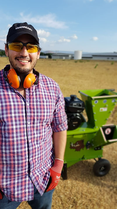a satisfied customer standing right next to a Yardbeast 2050 that just got used to clear tree debris from a recent storm