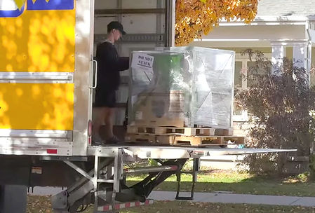 a freight truck delivery is seen delivering a Yardbeast 2090 by using a truck lift gate. The chipper arrives packaged and in excellent condition after the customer ordered it at our website online