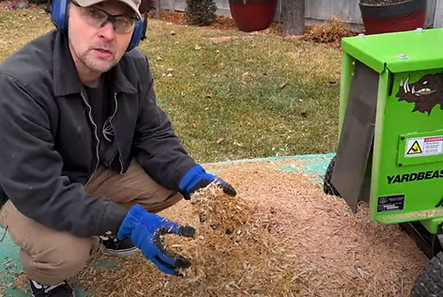 a user explaining the mulch created by a Yardbeast chipper shredder and the value that these chips can give to the soil, like retaining moisture and fertilizing the soil when decomposed